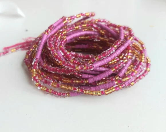 Deep pink and gold waist beads, glass and vinyl