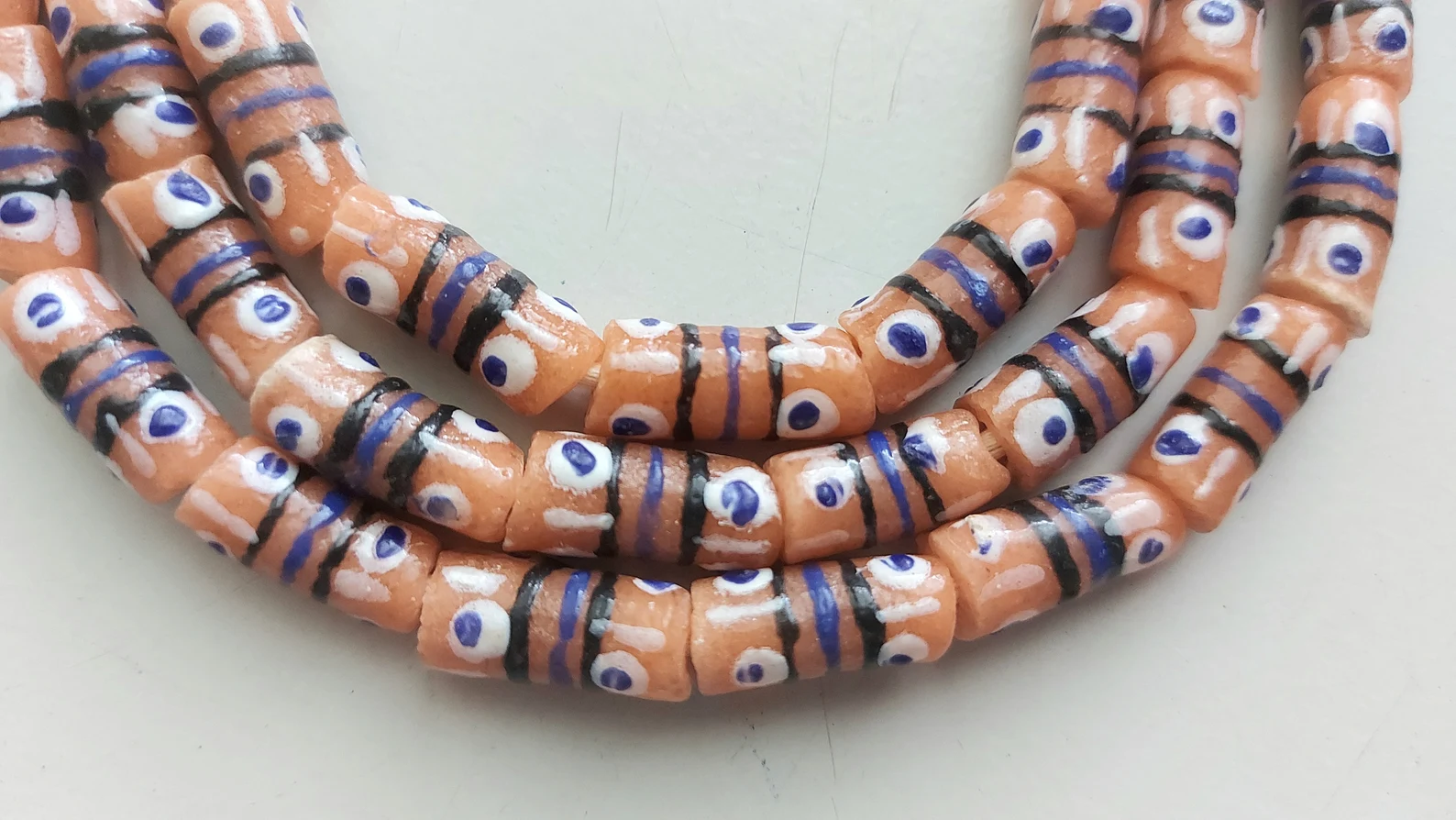 26 inches strand, African small painted beads, 7-8 x 16-18 mm., peach orange 26 inches strand, African small painted beads, 7-8 x 16-18 mm., peach orange